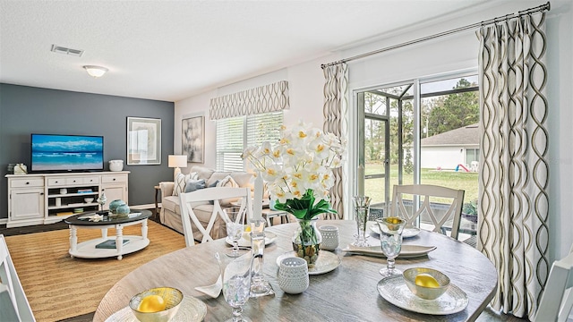 dining room featuring visible vents and wood finished floors