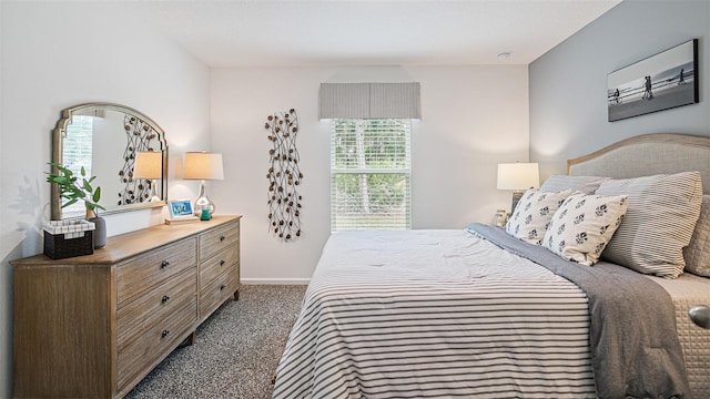 bedroom featuring carpet floors, baseboards, and multiple windows