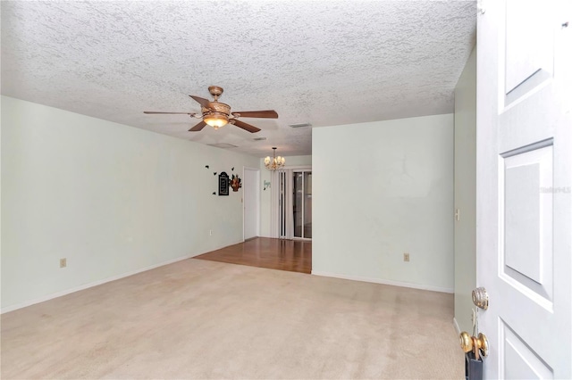 8720 SW 108th Ln, Ocala, FL 34481 - carpeted empty room with baseboards, a textured ceiling, and ceiling fan with notable chandelier