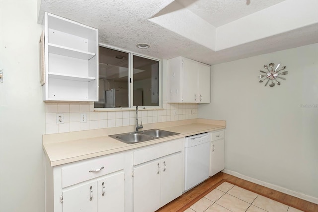 8720 SW 108th Ln, Ocala, FL 34481 - kitchen with dishwasher, white cabinetry, a sink, light wood-style flooring, and backsplash