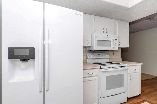 8720 SW 108th Ln, Ocala, FL 34481 - kitchen featuring white appliances, white cabinets, light wood-style flooring, and light countertops