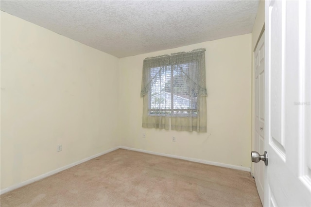 8720 SW 108th Ln, Ocala, FL 34481 - empty room with light colored carpet, a textured ceiling, and baseboards