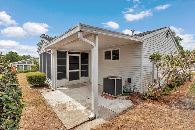 8720 SW 108th Ln, Ocala, FL 34481 - back of property featuring a sunroom, central AC unit, and a patio area