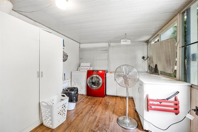 laundry room featuring laundry area, washing machine and dryer, and wood finished floors