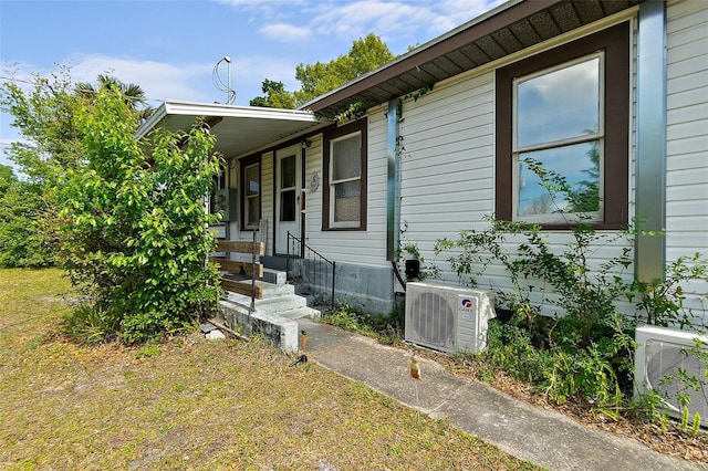 view of side of home with ac unit