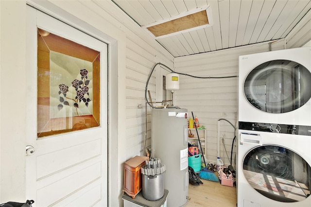 laundry room with laundry area, wood finished floors, stacked washing maching and dryer, wooden ceiling, and water heater