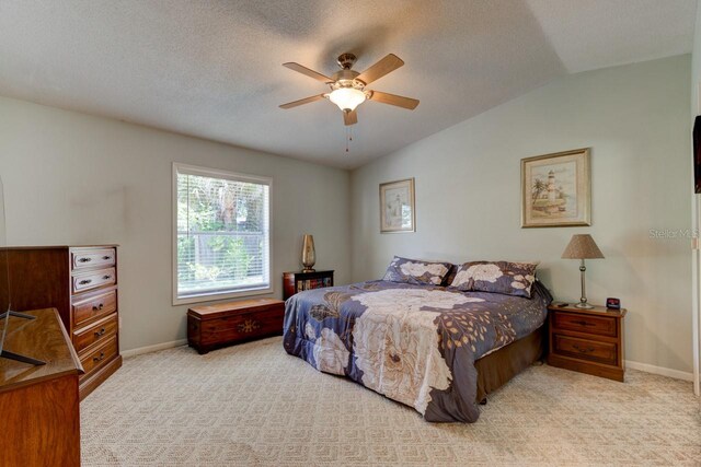 bedroom featuring baseboards, vaulted ceiling, ceiling fan, and carpet