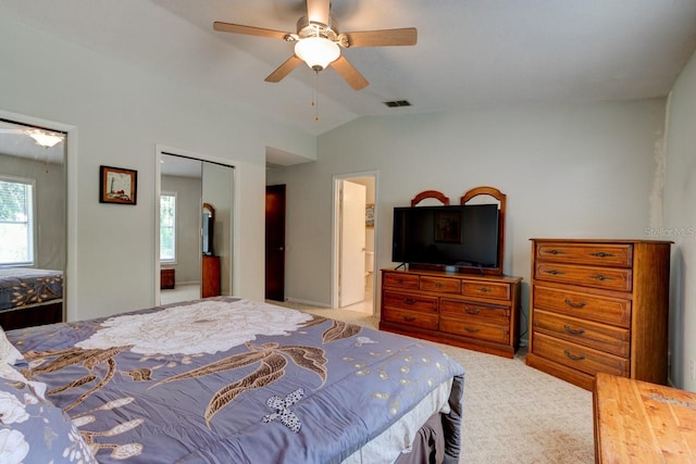 bedroom with carpet flooring, ceiling fan, vaulted ceiling, visible vents, and a closet