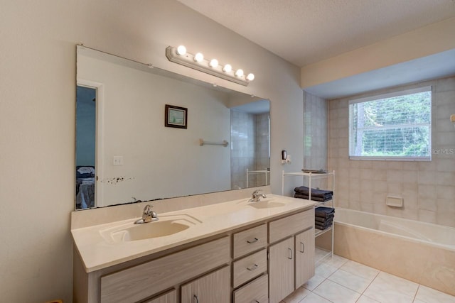 full bathroom with double vanity, tile patterned flooring, a sink, and a tub to relax in