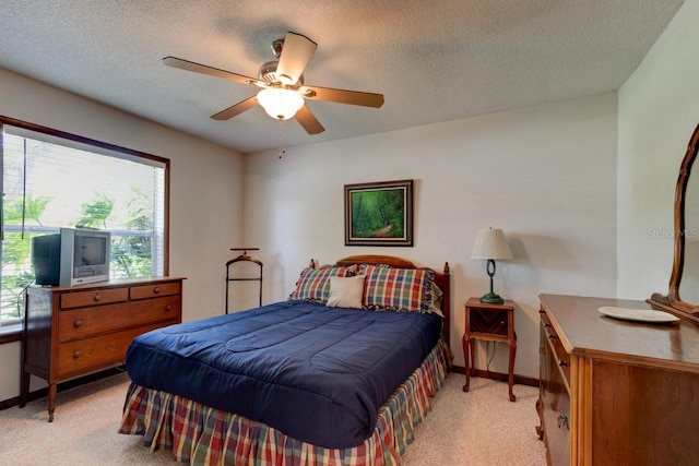 bedroom with baseboards, multiple windows, and light colored carpet