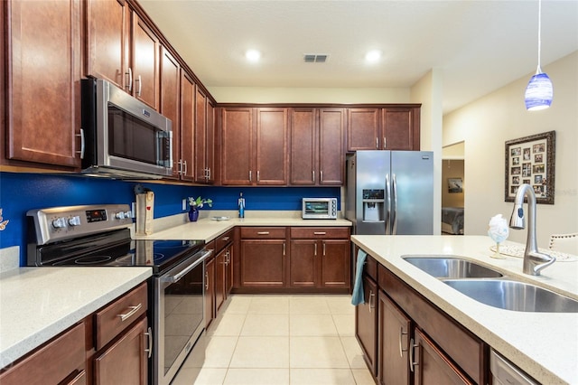 35 Park Place Cir, Palm Coast, FL 32164 - kitchen featuring visible vents, light tile patterned flooring, light countertops, a sink, and stainless steel appliances