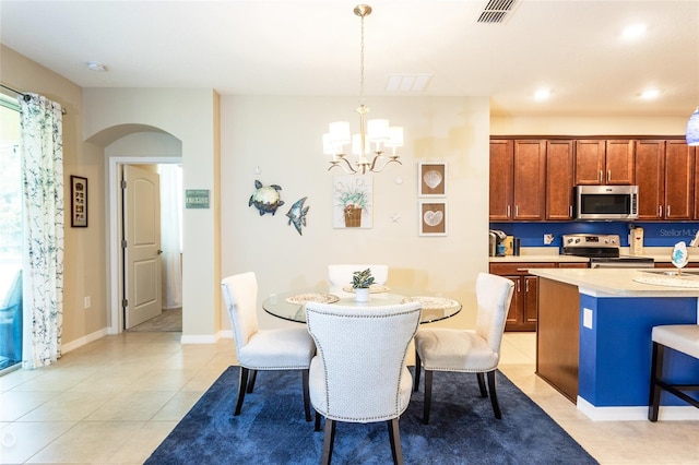 35 Park Place Cir, Palm Coast, FL 32164 - dining space with visible vents, an inviting chandelier, light tile patterned flooring, baseboards, and arched walkways