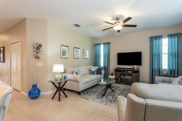 35 Park Place Cir, Palm Coast, FL 32164 - living room with visible vents, baseboards, ceiling fan, and a healthy amount of sunlight