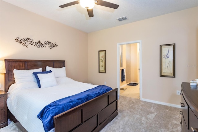 35 Park Place Cir, Palm Coast, FL 32164 - bedroom featuring ceiling fan, light colored carpet, ensuite bath, baseboards, and visible vents