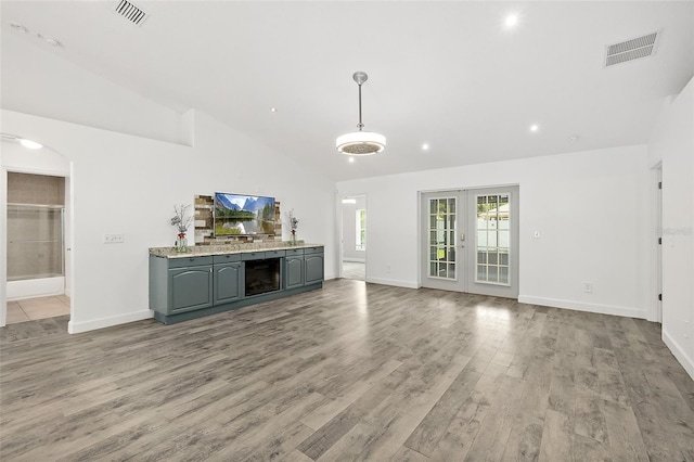23 Essington Ln, Palm Coast, FL 32164 - unfurnished living room with baseboards, visible vents, and light wood-style flooring