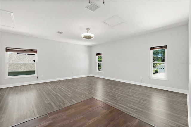 23 Essington Ln, Palm Coast, FL 32164 - empty room with baseboards, attic access, dark wood-type flooring, and visible vents