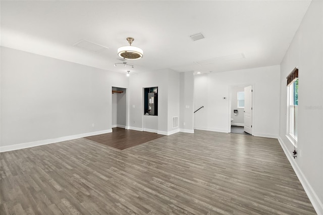 23 Essington Ln, Palm Coast, FL 32164 - unfurnished living room featuring baseboards, dark wood finished floors, and visible vents