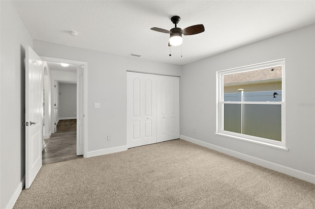 23 Essington Ln, Palm Coast, FL 32164 - unfurnished bedroom featuring baseboards, a ceiling fan, carpet, and a closet