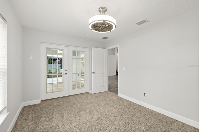 23 Essington Ln, Palm Coast, FL 32164 - carpeted empty room with baseboards, visible vents, and french doors