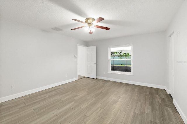 23 Essington Ln, Palm Coast, FL 32164 - spare room with baseboards, a ceiling fan, a textured ceiling, and wood finished floors