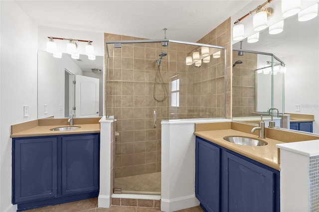 23 Essington Ln, Palm Coast, FL 32164 - bathroom with a sink, tile patterned flooring, a shower stall, and two vanities