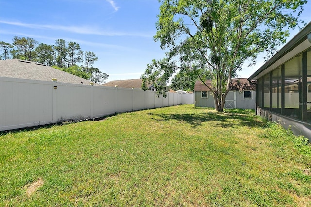 23 Essington Ln, Palm Coast, FL 32164 - view of yard featuring an outdoor structure, a fenced backyard, a storage shed, and a sunroom