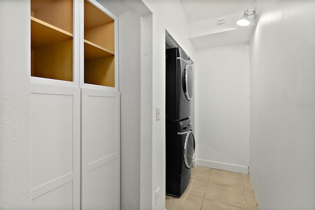 23 Essington Ln, Palm Coast, FL 32164 - laundry room with laundry area, stacked washer and dryer, baseboards, and light tile patterned floors