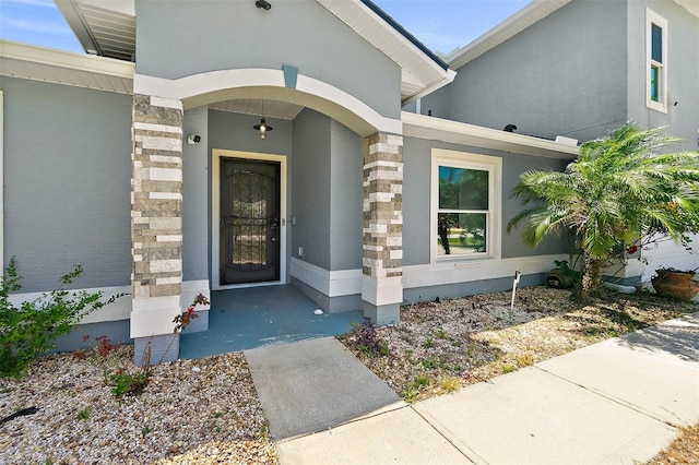 23 Essington Ln, Palm Coast, FL 32164 - property entrance with stone siding and stucco siding