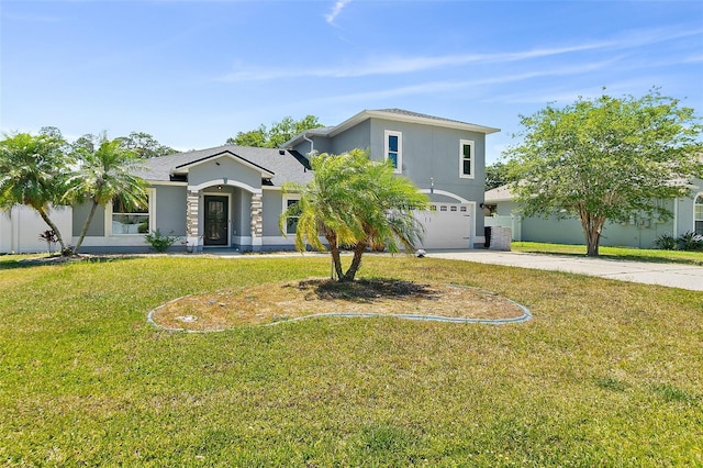 23 Essington Ln, Palm Coast, FL 32164 - view of front of home featuring concrete driveway, stucco siding, a front lawn, and a garage