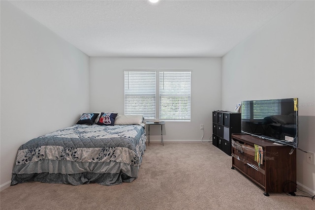 bedroom featuring baseboards and light colored carpet