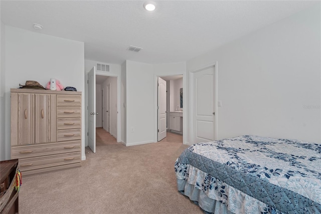 bedroom featuring visible vents, baseboards, and light colored carpet
