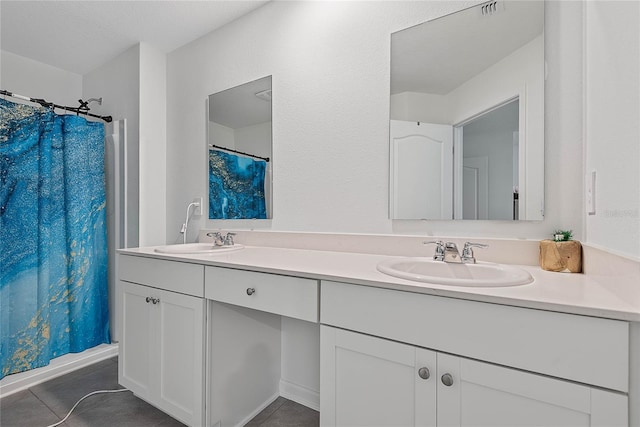 full bathroom with a sink, tile patterned flooring, and double vanity