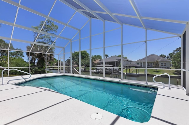 pool with glass enclosure and a patio