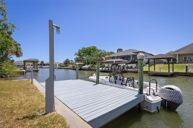 view of dock featuring a residential view, a water view, and a lawn