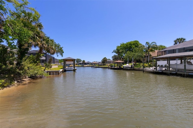 view of dock with a residential view and a water view