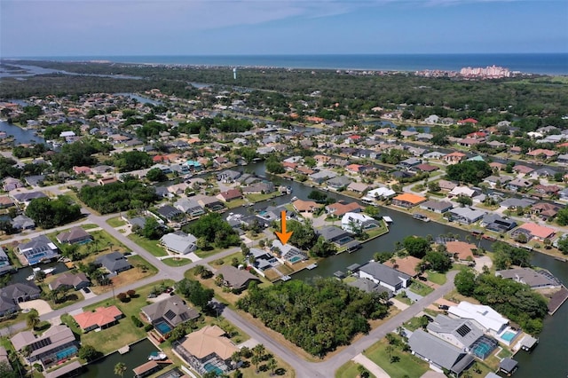drone / aerial view with a residential view and a water view