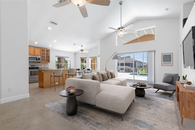 living area featuring a ceiling fan, visible vents, plenty of natural light, and recessed lighting