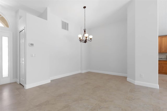 interior space featuring a notable chandelier, visible vents, plenty of natural light, and baseboards