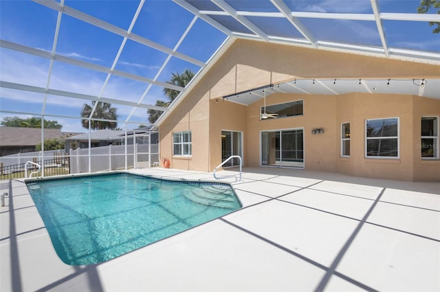 view of swimming pool featuring a ceiling fan, a patio area, glass enclosure, fence, and a fenced in pool