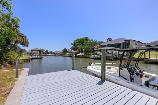 dock area featuring a water view and a residential view