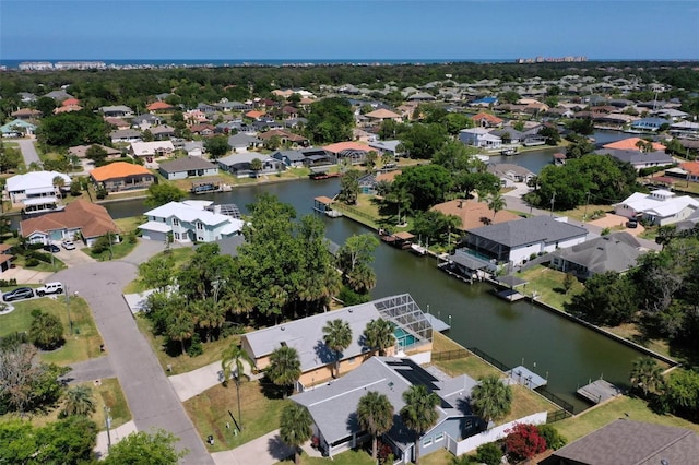 birds eye view of property with a water view and a residential view