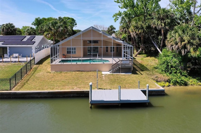 view of dock with a fenced backyard, a fenced in pool, a water view, glass enclosure, and a yard