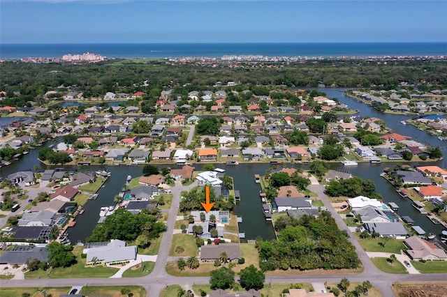 drone / aerial view featuring a residential view and a water view