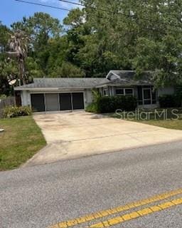 view of front of home with a garage, driveway, and a front lawn