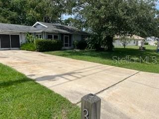 39 Bird Of Paradise Dr, Palm Coast, FL 32137 - single story home with driveway, a front lawn, and an attached garage