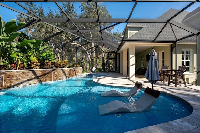 outdoor pool featuring a patio area and glass enclosure