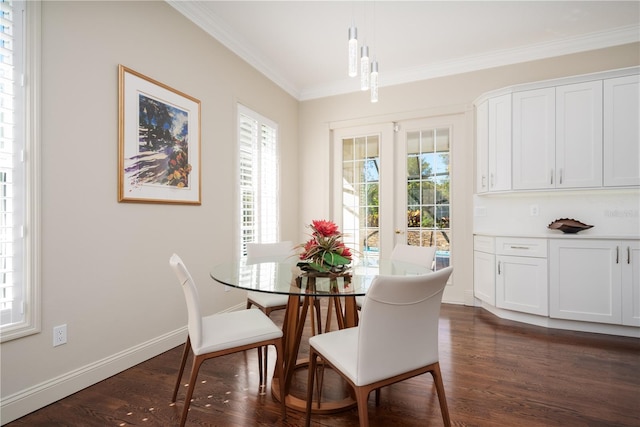 dining room with crown molding, dark wood-style floors, and baseboards