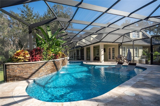 outdoor pool with a patio, glass enclosure, french doors, and central AC