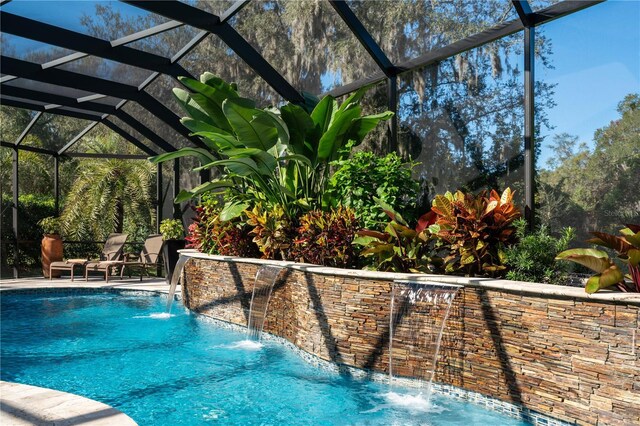 swimming pool featuring a lanai and a patio area
