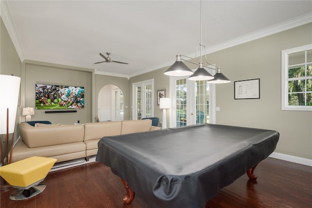 playroom with french doors, dark wood-style floors, baseboards, crown molding, and arched walkways